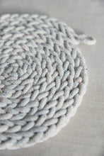 Load image into Gallery viewer, Shop at Settle The Chemists Daughter - close-up of a lovely, circle woven trivet handmade from 100% recycled pale cotton, set against a pale background