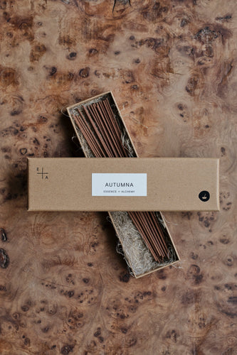 Natural cardboard packet of Autumna incense sticks by Essence + Alchemy, the box lid is open and laid across the box of sticks, which is lying on a natural wooden surface | Settle Norfolk  