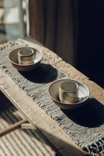 Load image into Gallery viewer, Shop with SETTLE | Cabin Woven - two handmade ceramic bowls are set on a handwoven table runner made from handspun wool, with tasselled ends and subtle brown on charcoal stripe, on an antique timber trestle at Settle. 