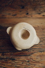 Load image into Gallery viewer, SETTLE | Every Story Ceramics Citrus Juicer - base view of a handmade ceramic citrus juicer showing its makers&#39; mark on its unglazed pale ceramic base, on antique timbers at Settle.