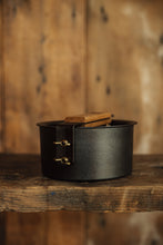 Load image into Gallery viewer, Shop at Settle | Netherton Foundry - cast iron glamping pot and lid in charcoal grey, with its wooden handle removed and affixed across its lid.