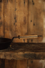 Load image into Gallery viewer, Shop with Settle | Netherton Foundry - close-up on wooden handle of a hand-spun cast iron glamping pan. 
