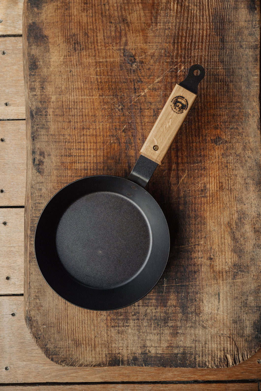 Shop with Settle | Netherton Foundry - overview of a black, hand-spun cast iron glamping pan with wooden oak handle.