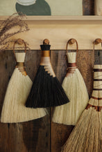 Load image into Gallery viewer, SETTLE | Wild Crafted Home Handmade Hand Brush - a selection of handmade brushes hanging on a row of pegs in Settle Shop at Settle.