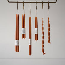 Load image into Gallery viewer, Skar Organics Paprika Candles suspended from meat hooks on a utilitarian rail by Skar Organics 