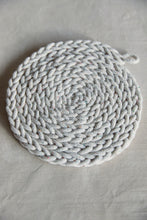 Load image into Gallery viewer, Shop at Settle The Chemists Daughter - close-up of a lovely, circle woven trivet handmade from 100% recycled pale cotton, set against a pale background