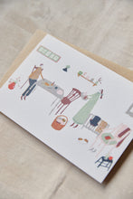 Load image into Gallery viewer, Shop at Settle | Harriet Watson Slow Sunday - charming hand illustrated colour greetings card of two guests enjoying the rustic interior of Carriage No. 1 at Settle, on a pale timber background.