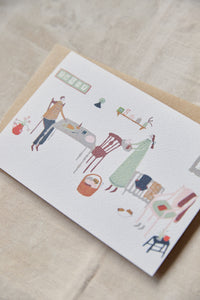 Shop at Settle | Harriet Watson Slow Sunday - charming hand illustrated colour greetings card of two guests enjoying the rustic interior of Carriage No. 1 at Settle, on a pale timber background.
