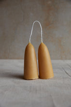 Load image into Gallery viewer, SETTLE - a pair of stubby candles, joined by a looped cotton wick and made from natural golden beeswax, set on a pale grey marble surface at Settle.