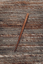 Load image into Gallery viewer, SETTLE | Steven Mackus Hand Carved Shawl Pin - a beautiful elegant pin handcarved from walnut wood rests on a natural woven brown wool shawl at Settle.
